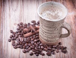 Cup of black coffee, cinnamon, aniseed and roasted coffee beans