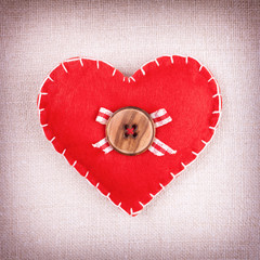 Red heart with wooden button and bow