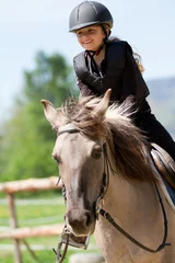 Fotobehang Horse riding - portrait of lovely equestrian on a horse © Gorilla
