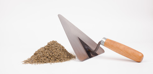 sand pile and mason trowel