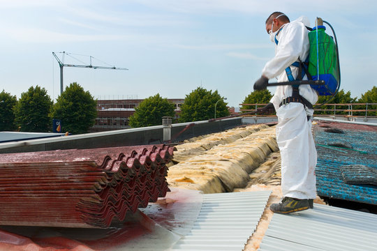 Worker During The Removal Of The Asbestos