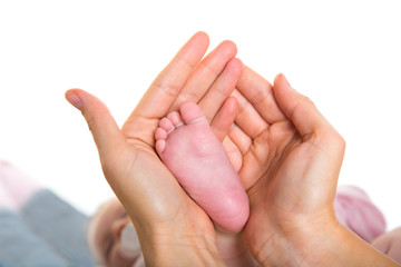 Mother hands holding baby nude feet on white