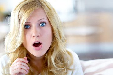 Blond woman with surprised look on her face