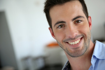 Fototapeta premium Portrait of handsome young man with blue shirt