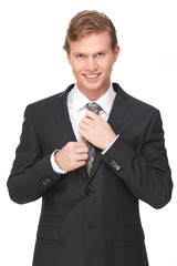 Attractive Businessman Smiling and Holding Tie