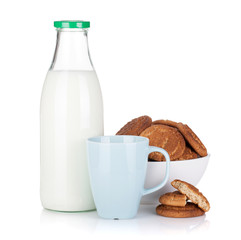 Cup, bottle of milk and bowl with cookies
