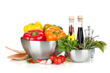 Fresh bell peppers and herbs in bowls