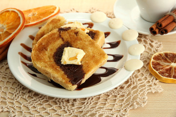 White bread toast with chocolate on wooden table