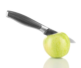 Green apple and knife isolated on white