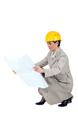 Female entrepreneur crouching on white background