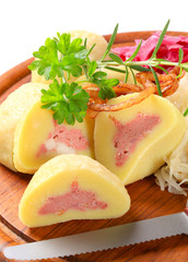 Meat stuffed potato dumplings with shredded cabbage