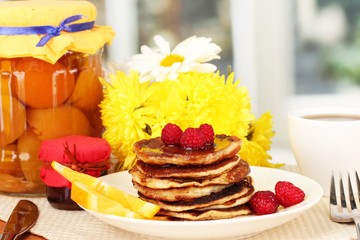 delicious sweet pancakes on bright background