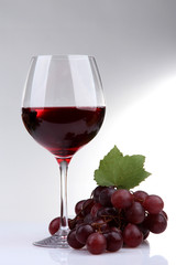 glass of wine and grapes, isolated on white