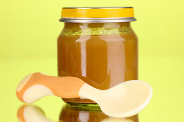 Useful and tasty baby food with beige small spoon