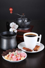 Cup of coffee with rahat delight, coffee pot and coffee mill