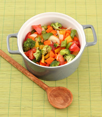 Vegetable stew in gray pot on bamboo mat background