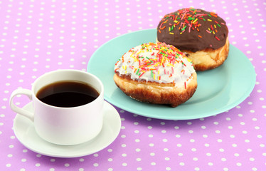 Tasty donuts on color plate on color background