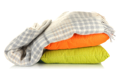 Woolen checkered plaid and pillows, isolated on white