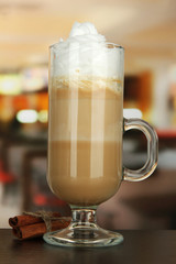 Fragrant coffee latte in glass cup with vanilla pods,