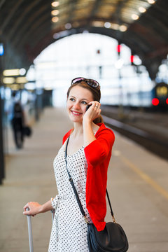 Pretty young woman at a train station