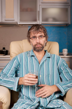 drunk man sitting in chair with glass