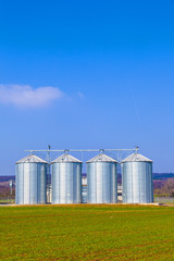 Fototapeta premium silver silos in field