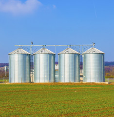 silver silos in field