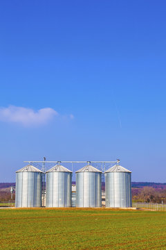 silver silos in field