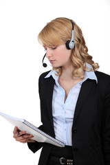 Call-center worker with note pad