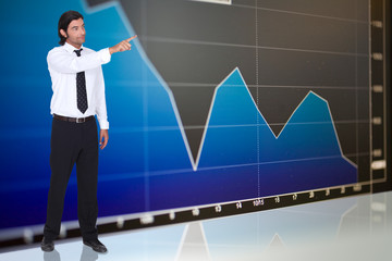tall dark-haired man standing before graph
