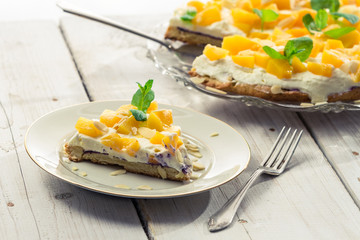 Closeup of cake with cream and peaches