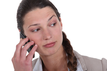 woman with cell phone looking puzzled