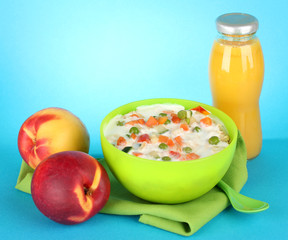 tasty dieting food and bottle of juice, on blue background