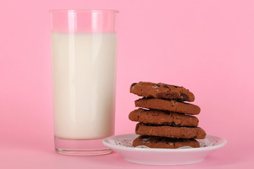 Glass of fresh new milk on pink background