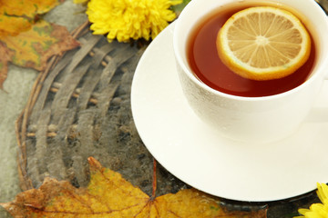 cup of hot drink and autumn leaves, close up