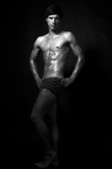 Fototapeta na wymiar Studio shot of strong fitness handsome sports man looking at the