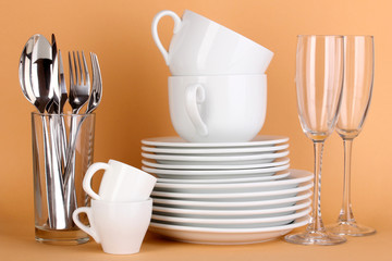 Clean white dishes on beige background