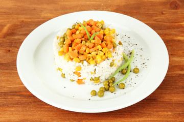 Risotto on plate on wooden background