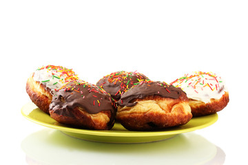 Tasty donuts on color plate isolated on white