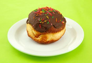 Tasty donuts on color plate on color background