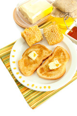 White bread toastwith honey on plate, isolated on white