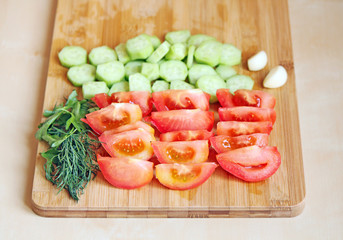 Cutted tomatoes and cucumbers with greens