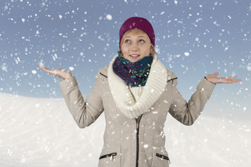 snowing on a young woman with hat and scarf