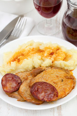 meat with chorizo and potato on the plate
