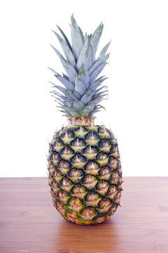 pineapple on wooden table whith white background