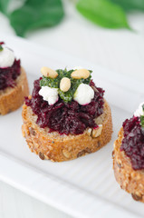 beet salad with pesto and goat cheese on toasted grain breads
