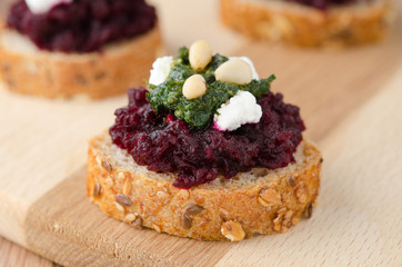 beet salad with pesto and goat cheese on toasted grain breads