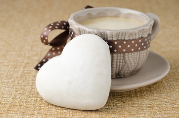 cookie with icing in the form of heart and a cup of coffee