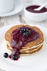 stack of pancakes with black currant jam