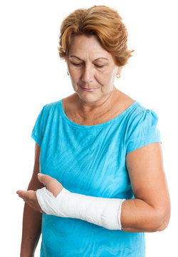 Woman with a broken arm on a plaster cast (isolated on white)